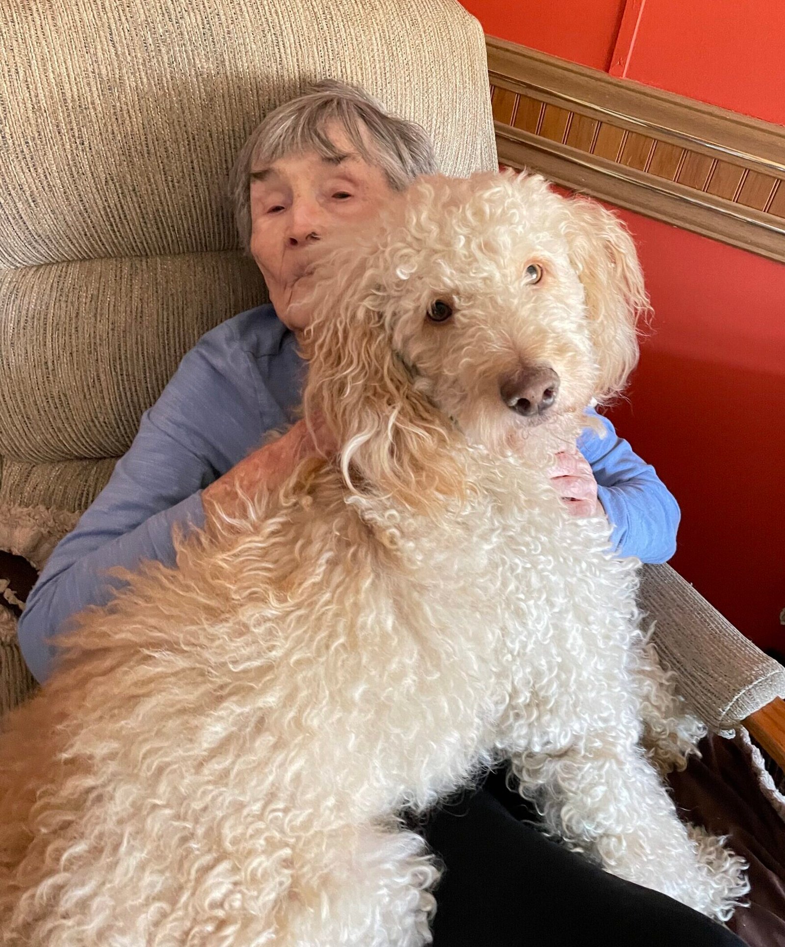 Jean sitting with Jr., her poodle mix companion, in Peoria, Arizona.